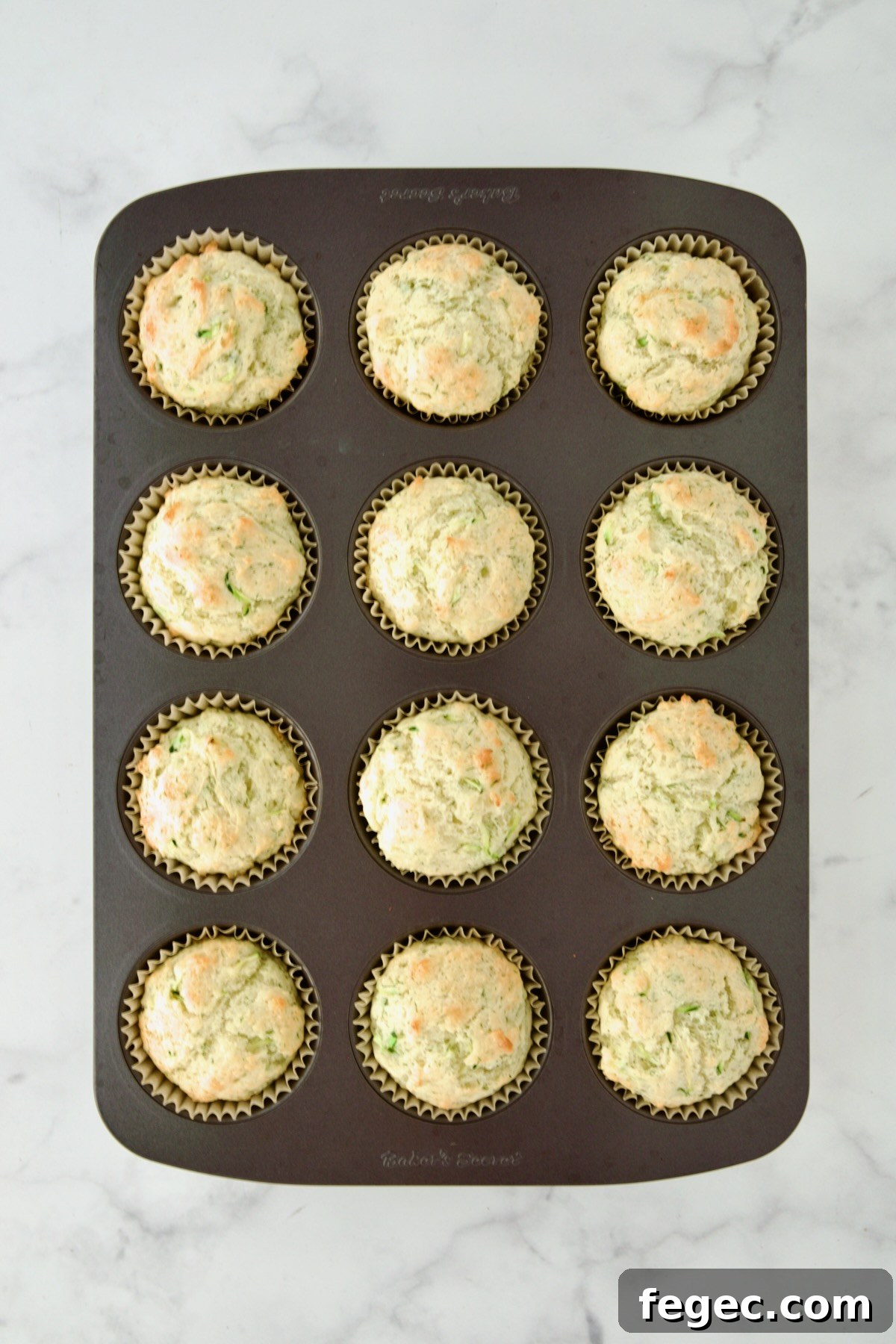 Baked Dill Zucchini and Ricotta Muffins in 12-cup muffin pan.
