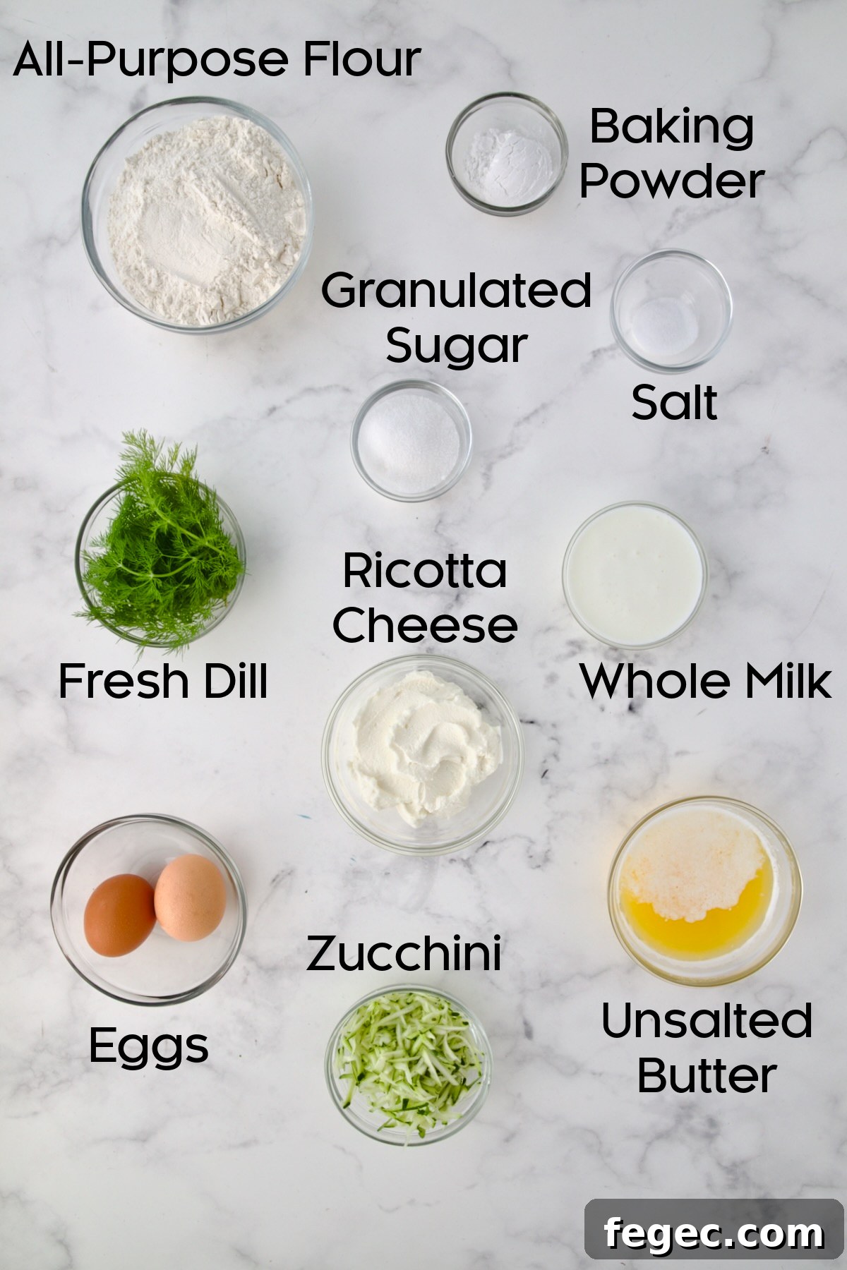 Ingredients for Dill Zucchini and Ricotta Muffins in glass bowls.
