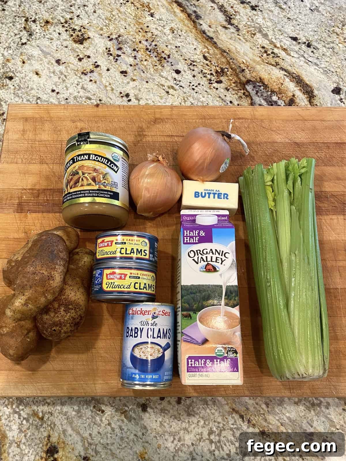Ingredients for clam chowder on a cutting board.