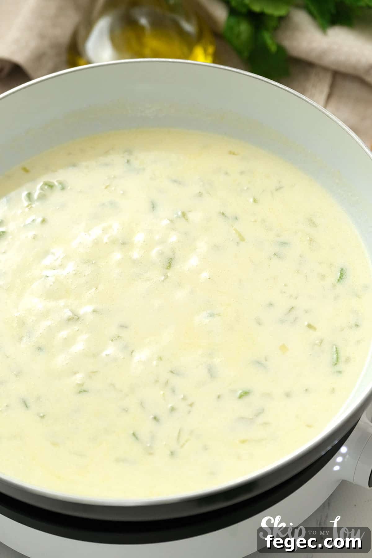 Large pan with cream added to the cooked celery and onions for the Tuna Noodle Casserole.