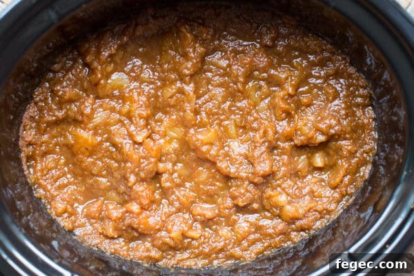 fully cooked pumpkin applesauce in a slow cooker cooling.