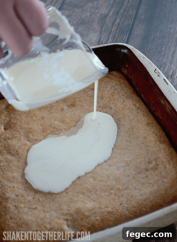 Pour cream cheese frosting over the top of this 3 Ingredient Banana Nut Muffin Cake for the finishing touch!