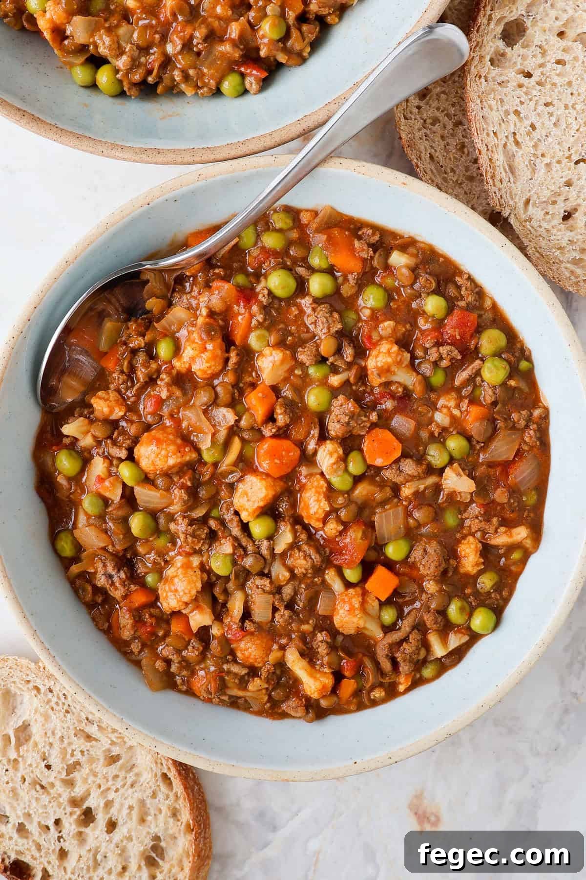 Savoury mince served in a bowl with a spoon.