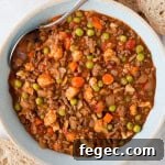 Savoury mince served in a bowl with a spoon.
