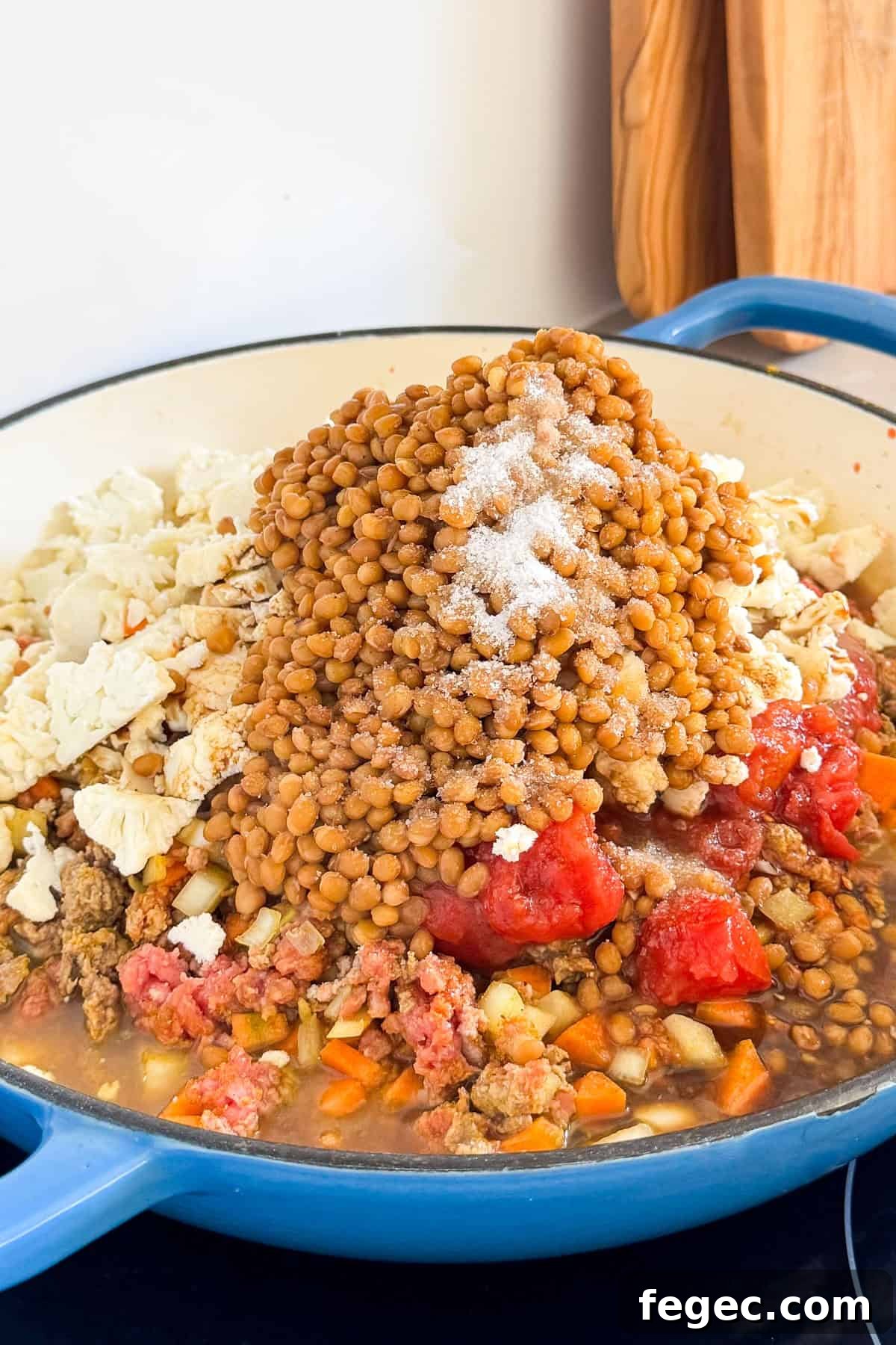 Lentils. cauliflower and canned tomatoes added to the pan.