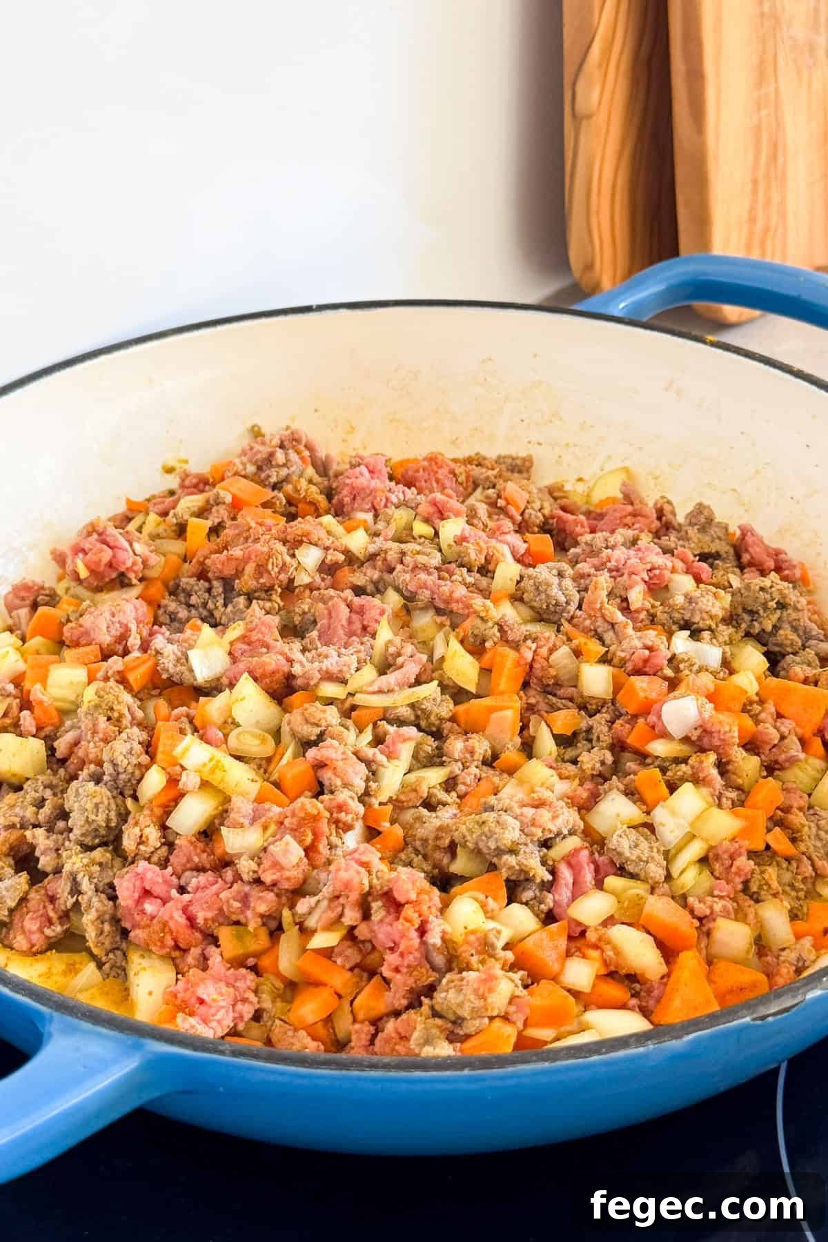 Ground mince and veggies cooking in a pan.