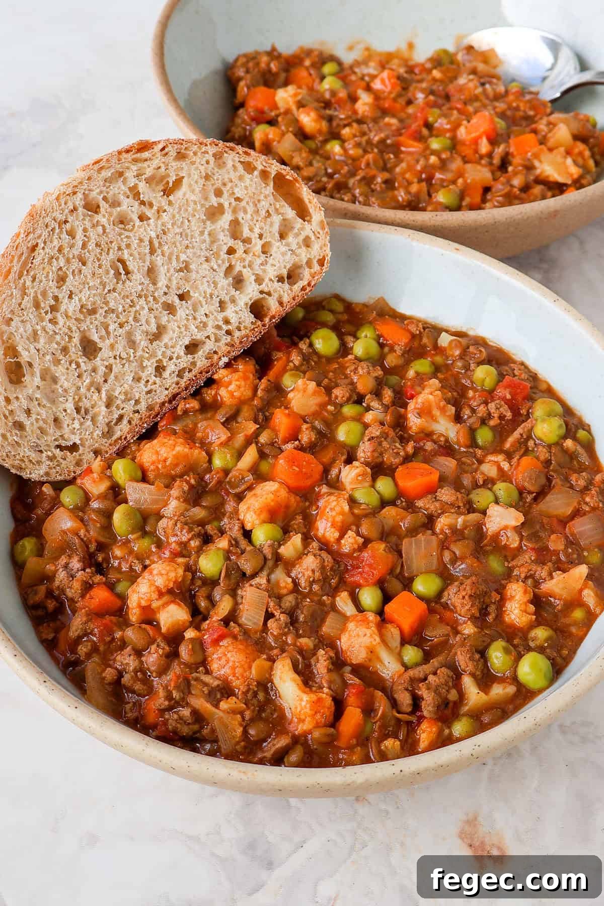 Side shot of the veggie mince served in a bowl with bread.