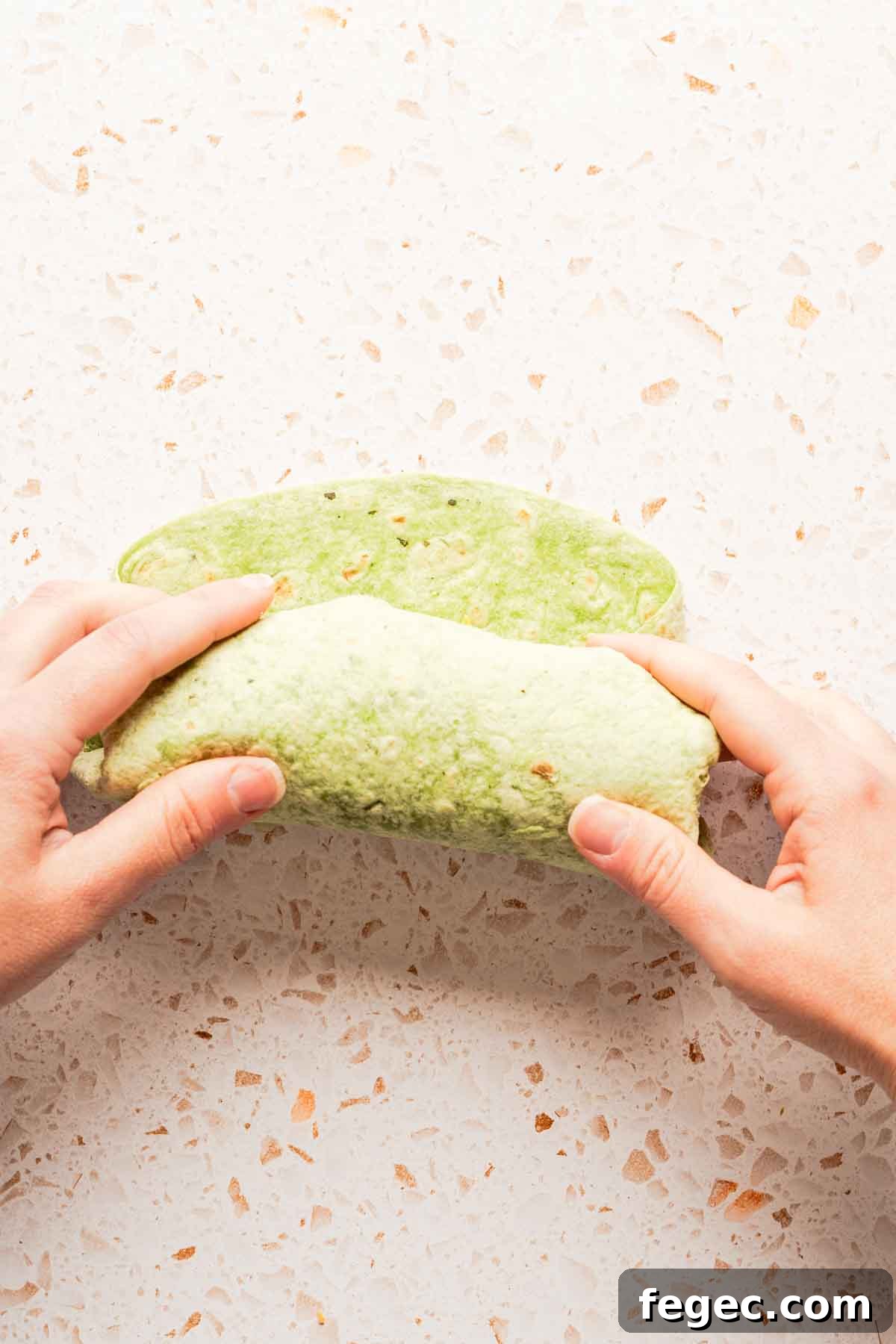 Crispy Tuna Melt Wrap Recipe for Quick Lunch or Picnic 11 tuna wrap being rolled up into burrito shape.