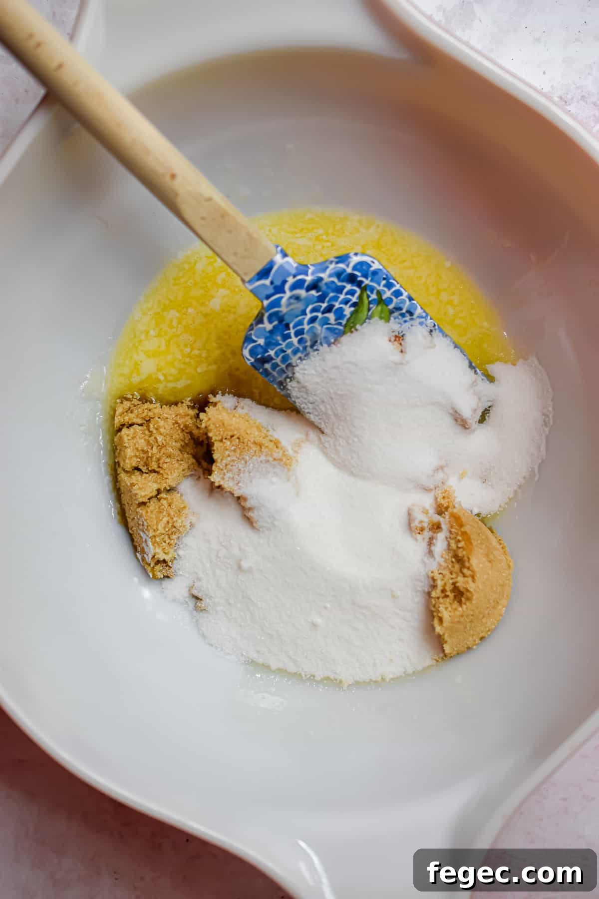 Sugars and butter are mixed together in a bowl.