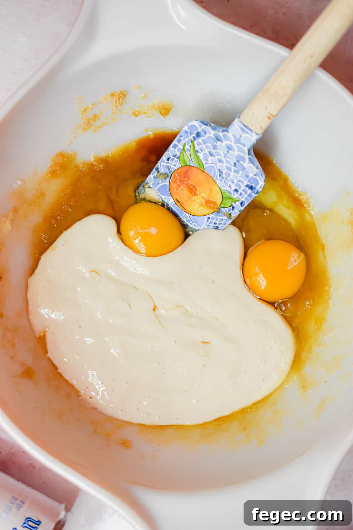 Eggs and sourdough starter are added to the bowl.
