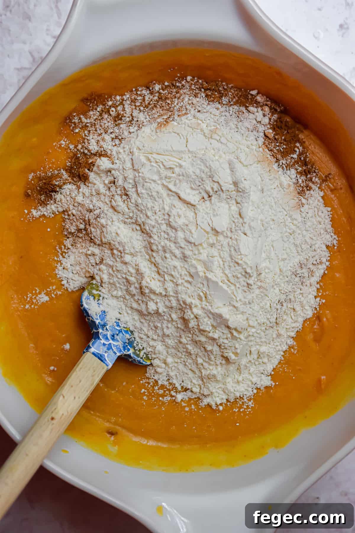 The dry ingredients are added to the bowl with the wet ingredients.