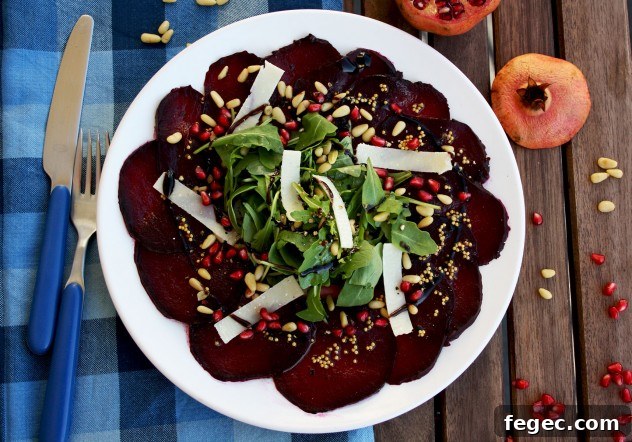 A beautiful, effortless, healthy and flavorful beetroot carpaccio with orange mustard vinaigrette and pomegranate seeds, served with parmesan and arugula.