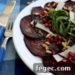A beautiful, effortless, healthy and flavorful beetroot carpaccio with orange mustard vinaigrette and pomegranate seeds, served with parmesan and arugula.