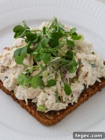 Close up of Chicken Salad Smørrebrød topped with microgreens.