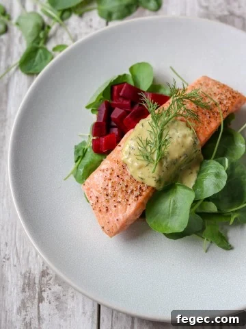 Salmon with mustard sauce, pickled beets and salad on a plate