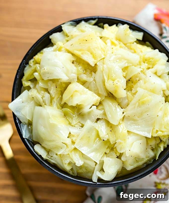 Buttered Cabbage in a black bowl on a wooden surface