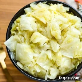 Buttered Cabbage in a black bowl on wooden surface