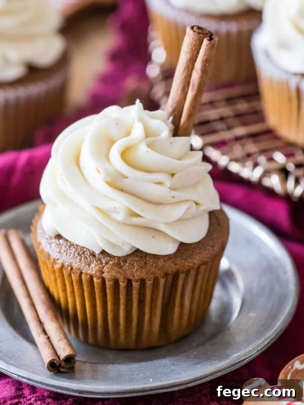 Gingerbread cupcake topped with a brown sugar cream cheese frosting and cinnamon sticks.