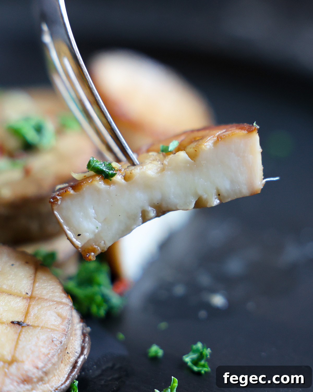 fork holding a slice of king oyster mushroom vegan scallop