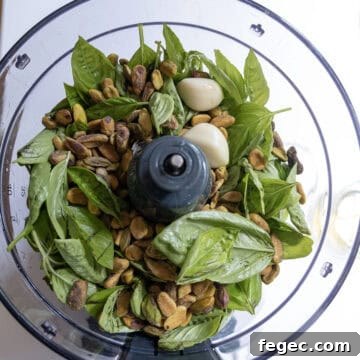 Ingredients for pesto in a food processor.