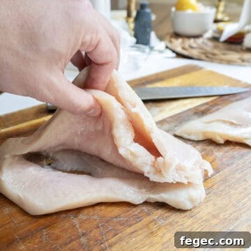 Chicken breast butterflied in thirds.