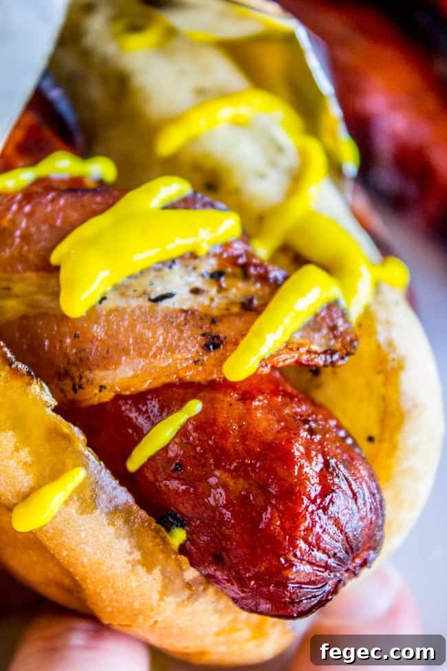 Grilled Bacon-Wrapped Hot Dogs: Crispy, Juicy Summer Recipe 7 Bacon Wrapped Hot Dogs (Grilled) from The Food Charlatan