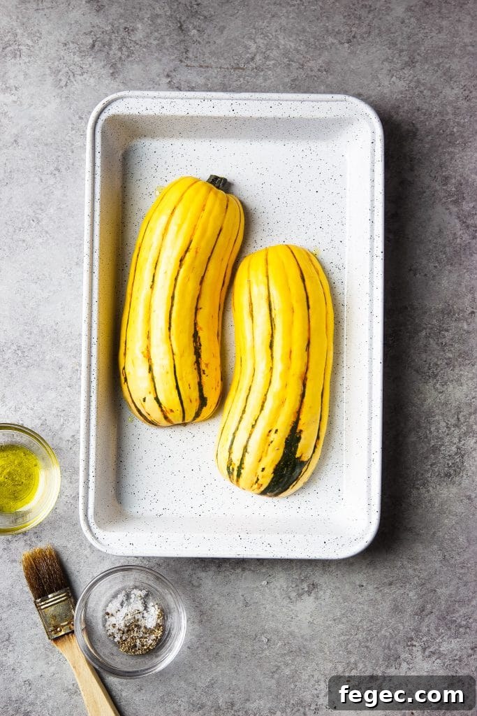 delicata squash in a roasting plan. Seasonings on the table.