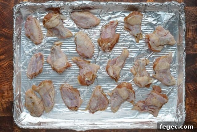 Hot honey chicken wings preparation: chicken wings on a foil lined baking pan.