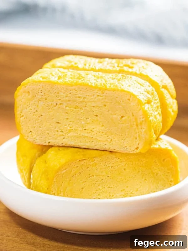 Tamagoyaki or Japanese rolled omelette in a small white bowl.