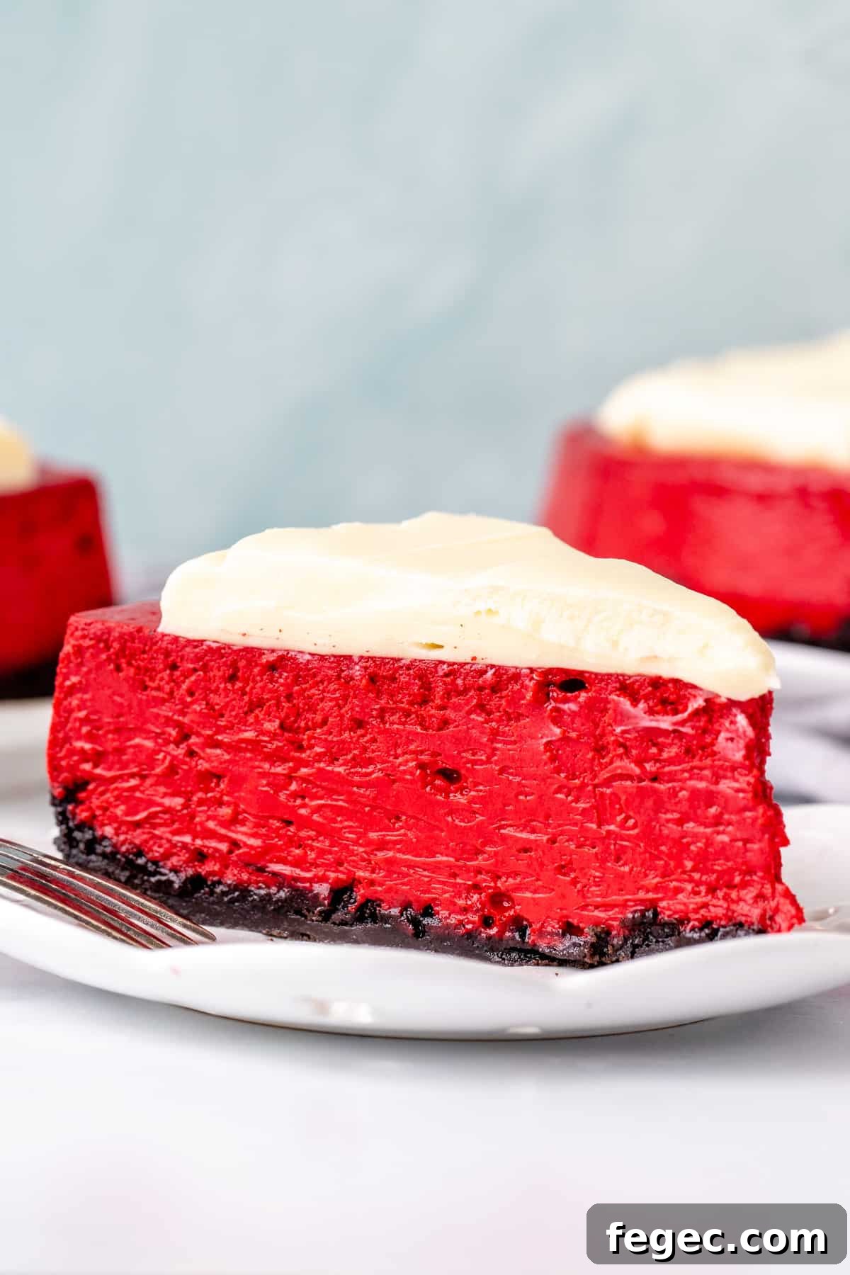 Slice of red velvet cheesecake with cream cheese topping