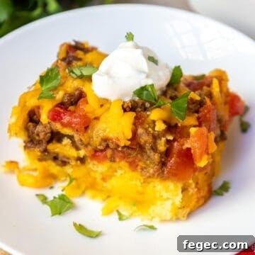 Mexican cornbread casserole topped with sour cream and cilantro.