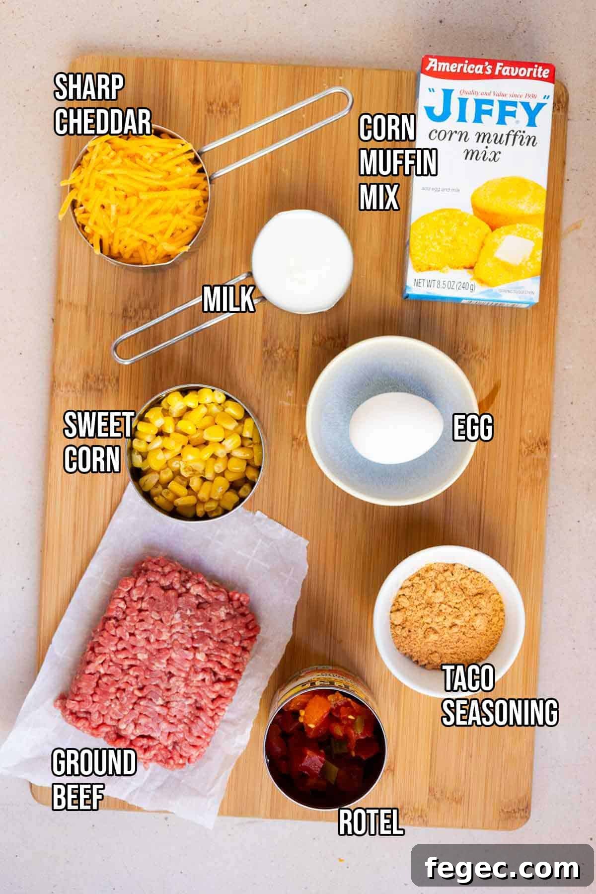 Mexican cornbread casserole ingredients: ground beef, Rotel, taco seasoing, Jiffy Corn Muffin Mix, milk, egg, sweet corn, and shredded cheddar.