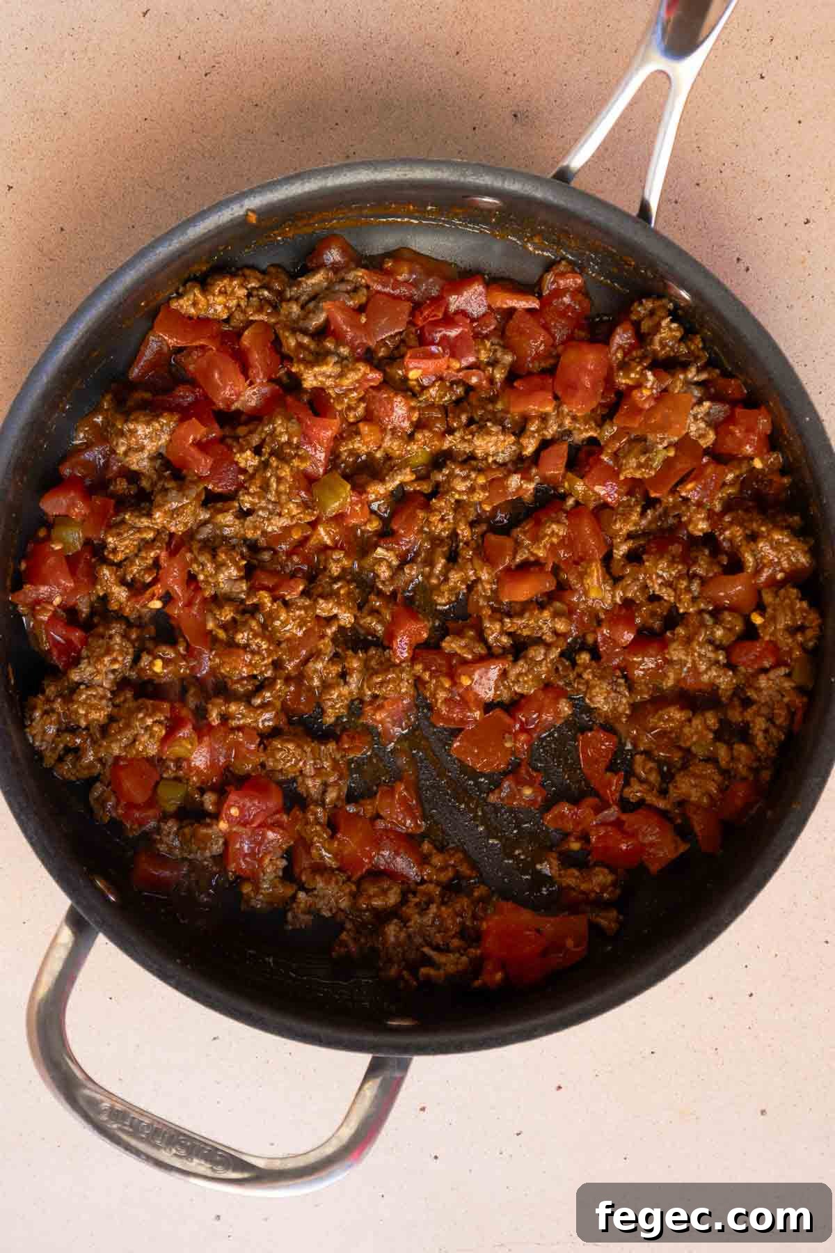 The ground beef and Rotel are mixed together in the large saucepan.