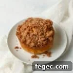 Single serve pumpkin coffee cake with streusel on a plate.