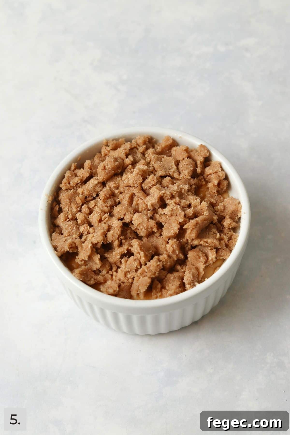 Single-Serve Pumpkin Coffee Cake Recipe (Small Batch) 8 Unbaked pumpkin streusel coffee cake in a ramekin.