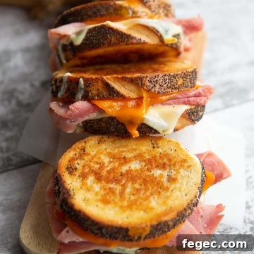 3 sandwiches lined up on a chopping board with focus on middle sandwich