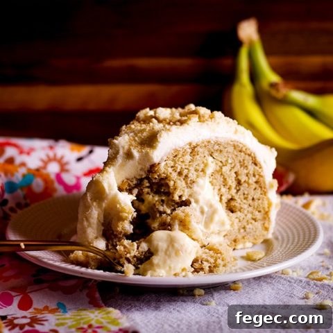 A slice of Banana Cream Cake on a plate with a fork.