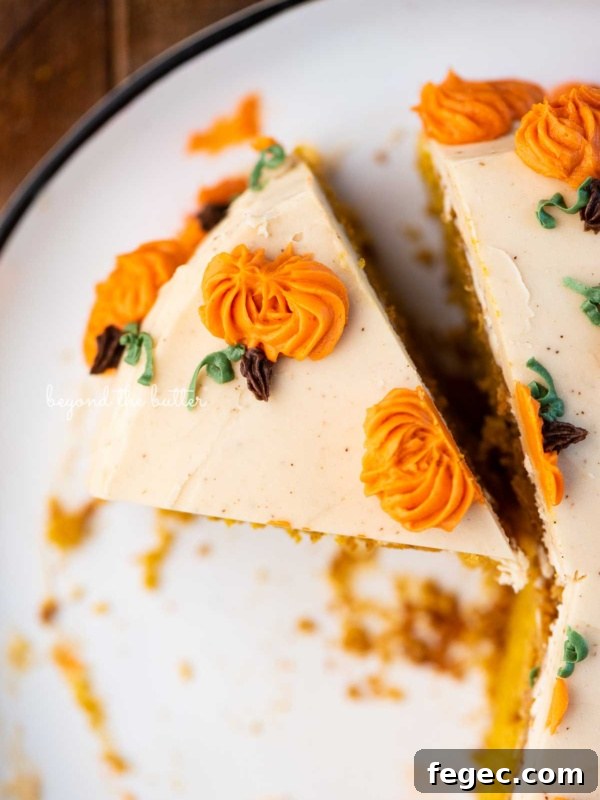 Slice of pumpkin spice cake on a black and white dessert plate.