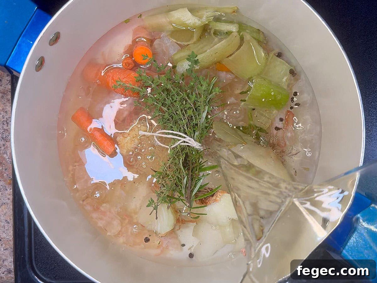 Pouring water over the shrimp shells and aromatics.