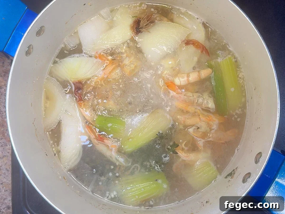 Bringing the shrimp stock to a simmer.