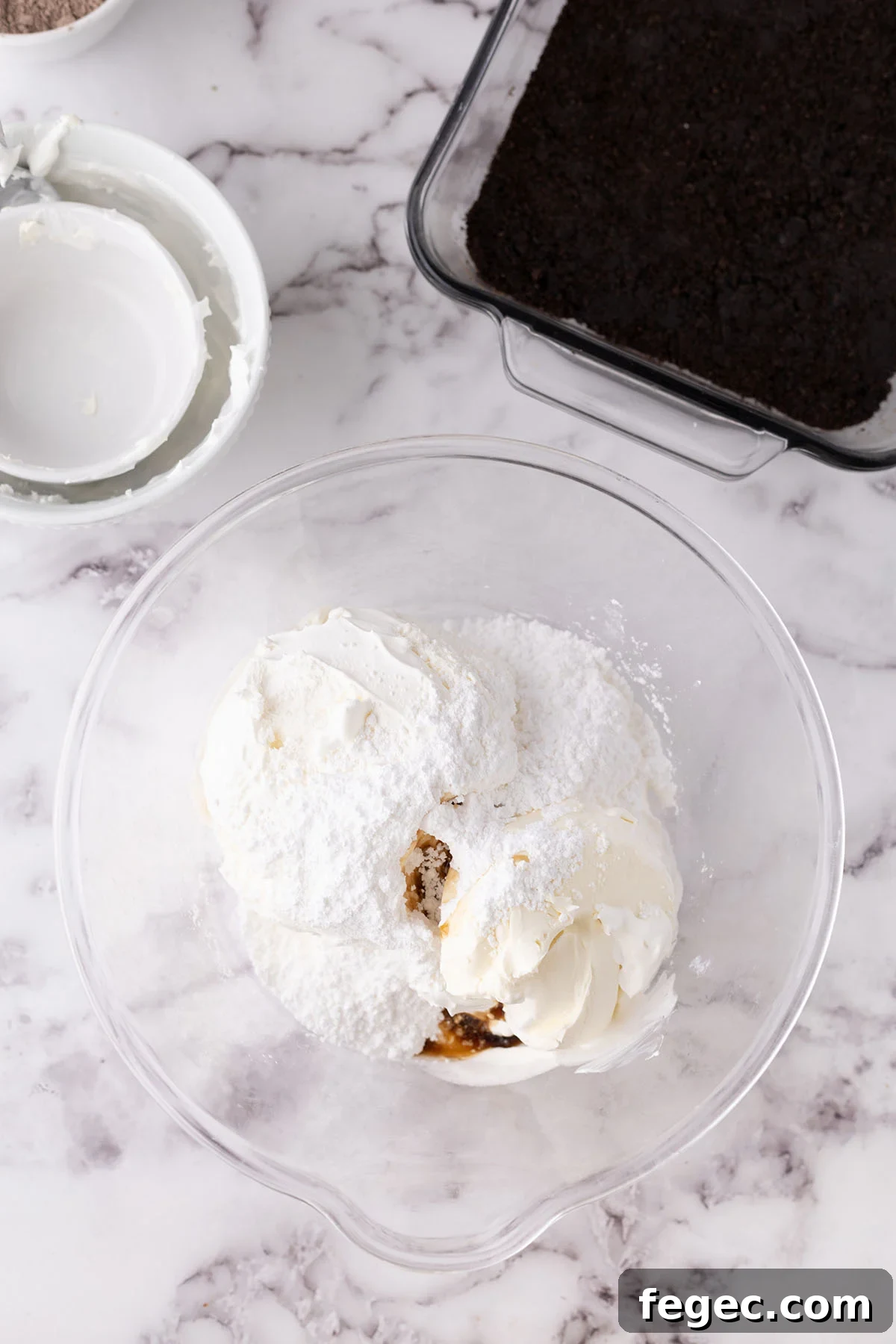 Cool whip, cream cheese, vanilla, and powdered sugar in a mixing bowl.
