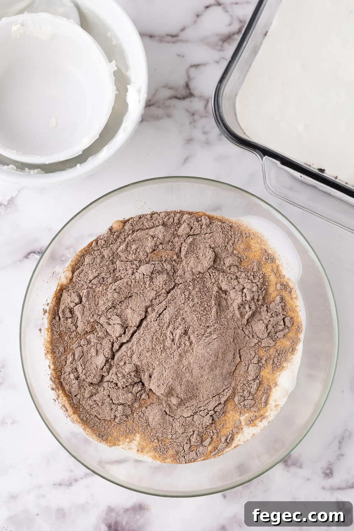 Heavy whipping cream and chocolate pudding mix in a mixing bowl.