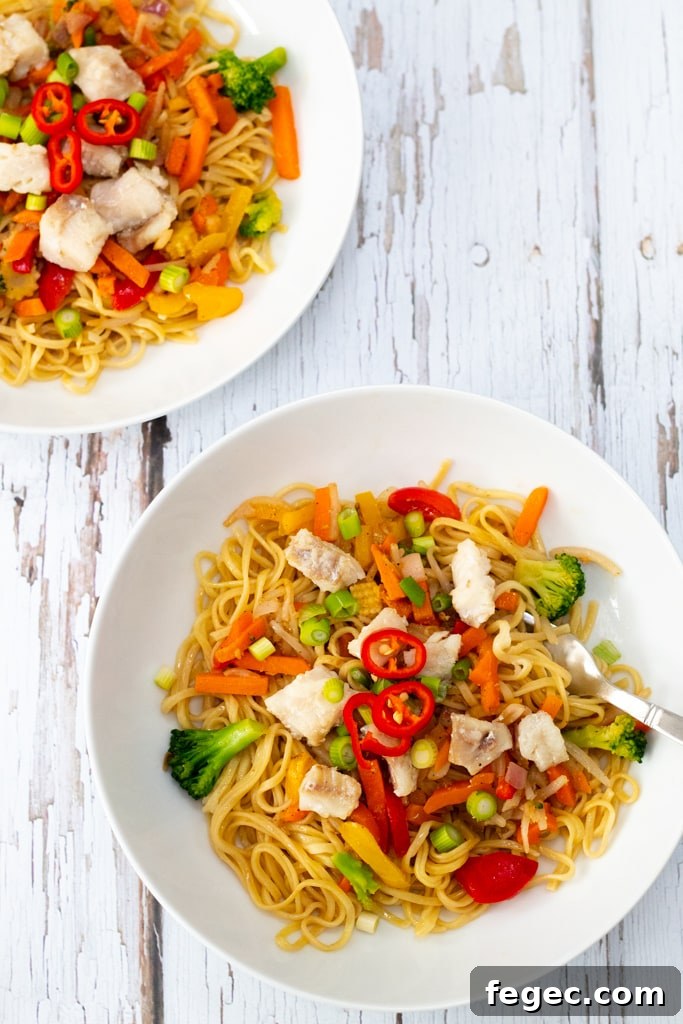 two bowls of stir fry noodles with Alaskan pollock