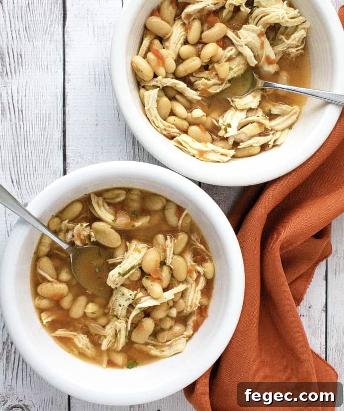 two white bowls filled with Instant Pot pressure cooker white chicken chili