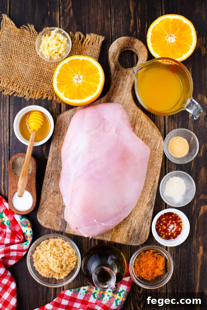 Oven-Roasted Turkey Breast with Honey Orange Glaze 4 Overhead shot of oven roasted turkey breast with orange sauce ingredients in bowls on a wooden table.