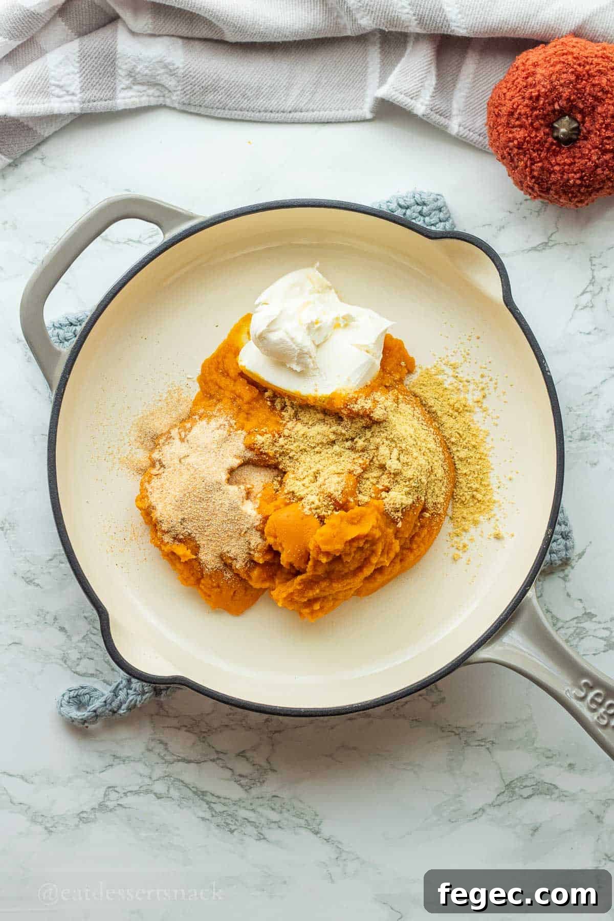 Pumpkin puree, cream cheese, and seasonings in pan.