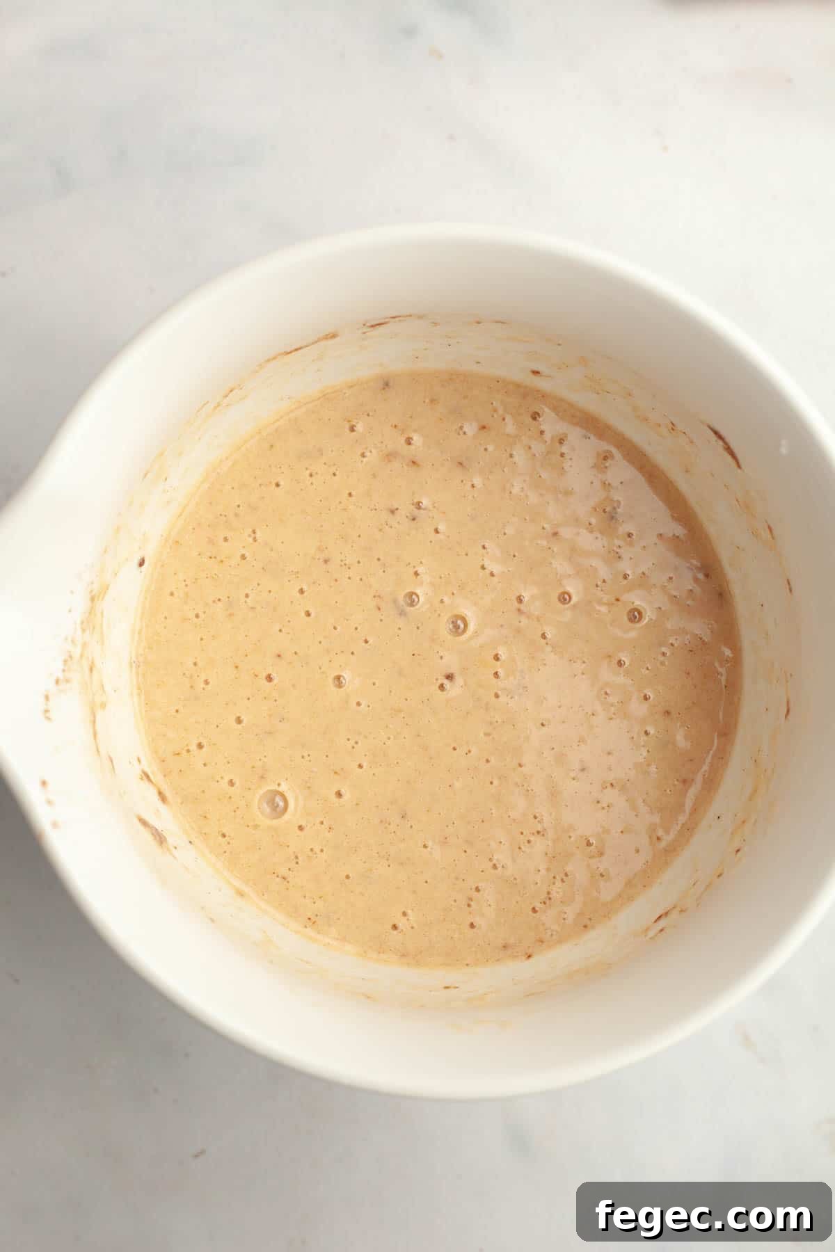 French toast buttermilk mixture in a white bowl.