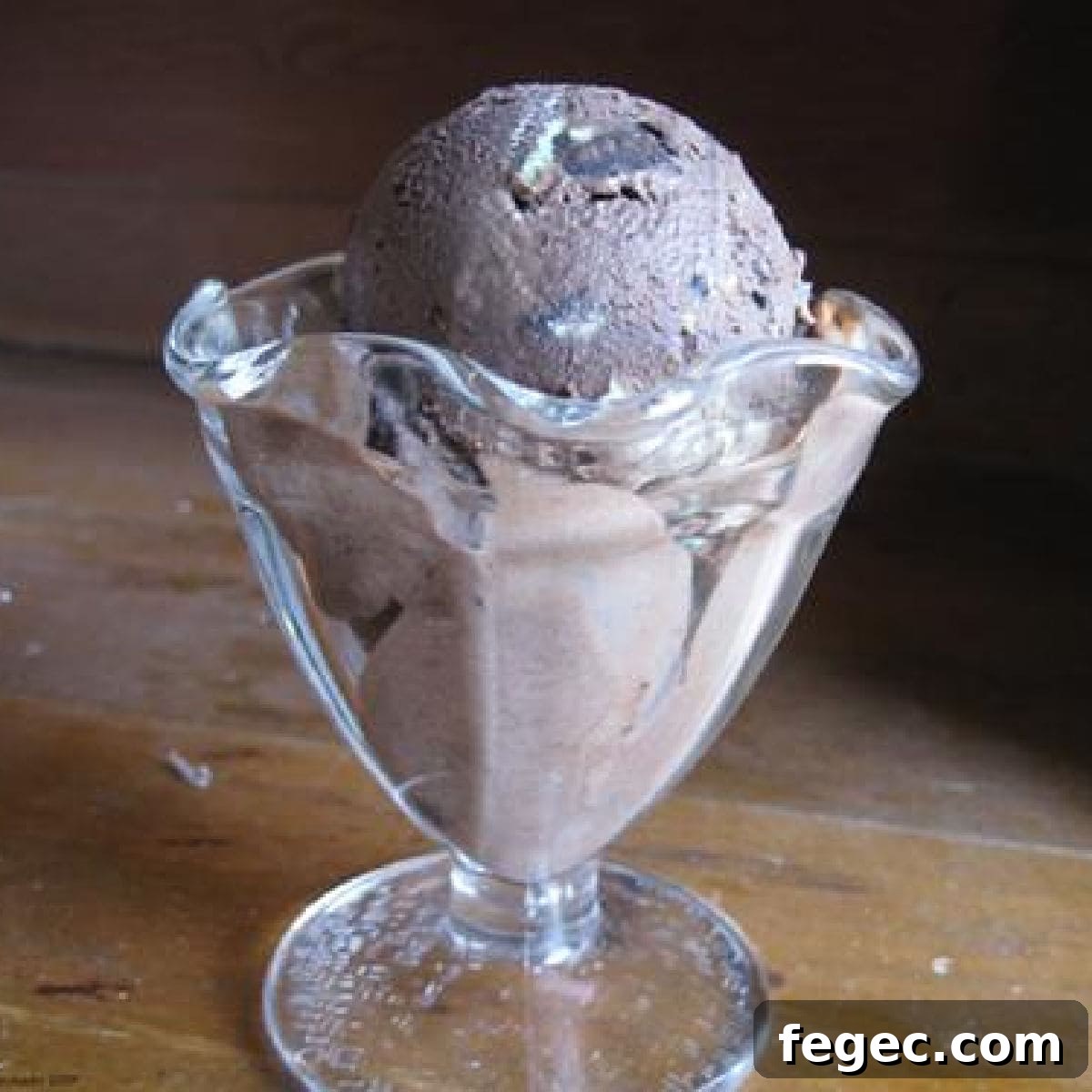 Chocolate Mint Oreo Chunk Ice Cream — Cool Mint Cookies & Cream Delight 2 A scoop of chocolate Oreo ice cream in a glass ice cream dish.