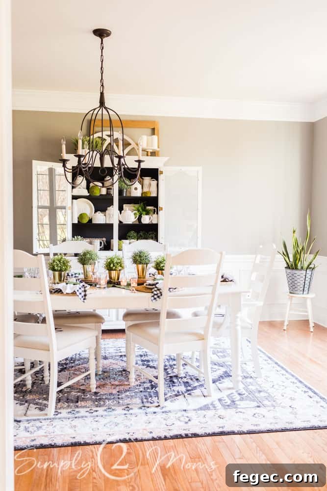 Spring Dining Room Ideas for Greenery Lovers 4 spring tablescape in dining room. table and six chairs on area rug with chandilier above table and china cabinet behind table