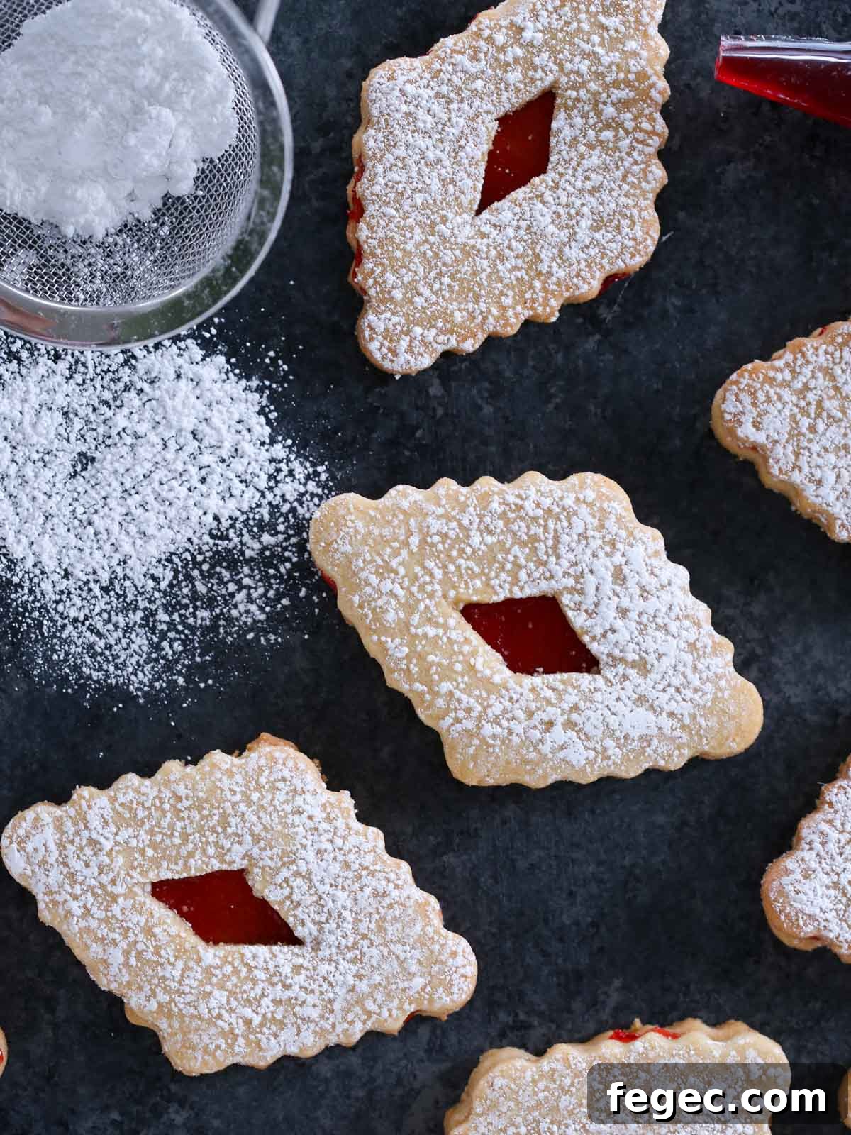 diamond shaped linzers with powdered sugar.